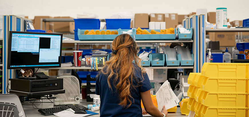 Woman working in pharmacy.