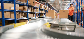 A distribution center working moving boxes along a conveyor belt