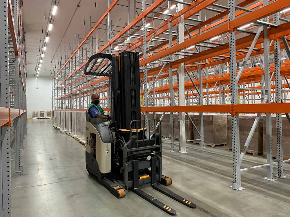 Forklift operator inside distribution facility