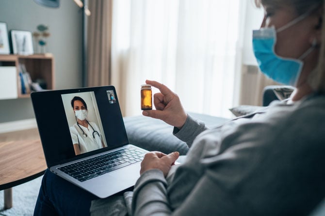 A patient using her cell phone to video call a physician