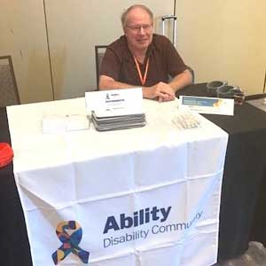 Terry mans a booth at an Ability ERG event.