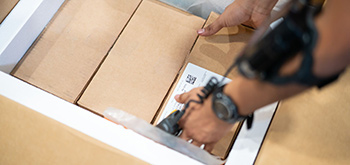 A person picking up a box
