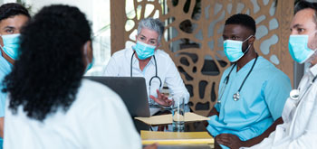 A group of healthcare professionals around a conference room table