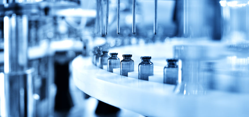 Close up of medicine vials on an assembly line