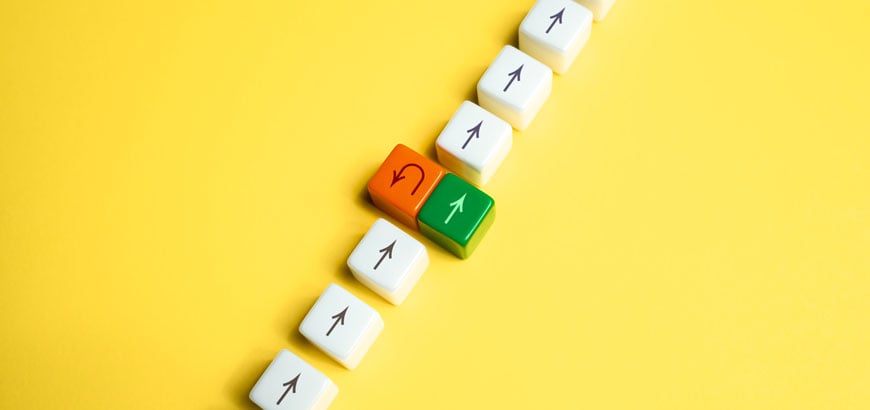 A series of square game pieces with arrows on them