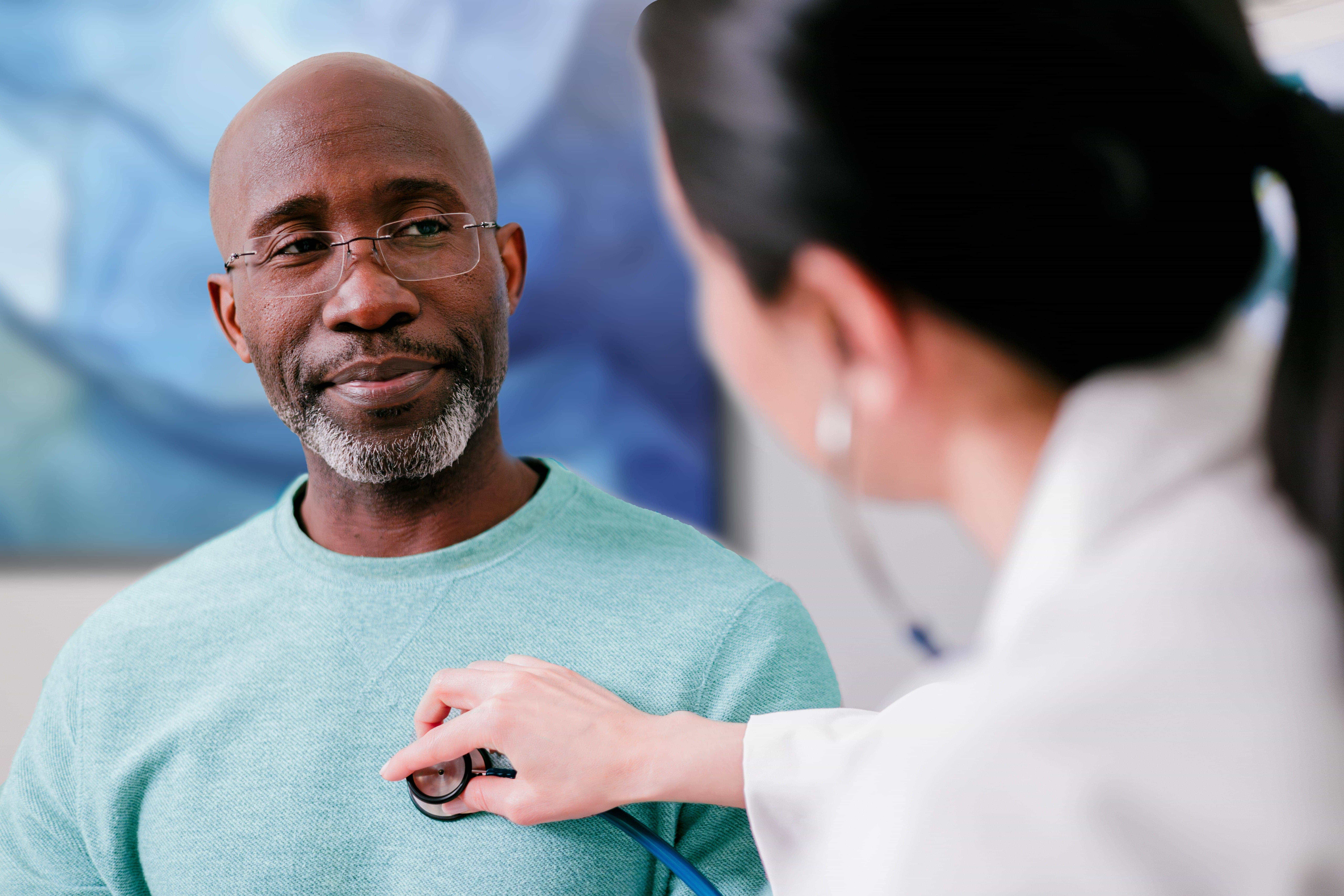 A doctor listens to a patient's heartbeat