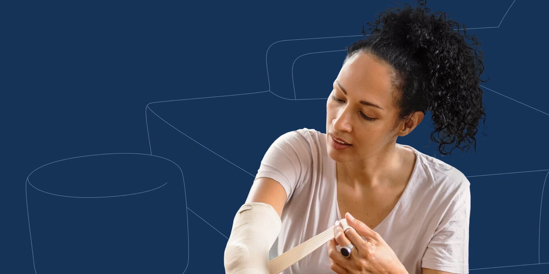 Person wrapping an elastic bandage around their elbow, sitting against a blue background.