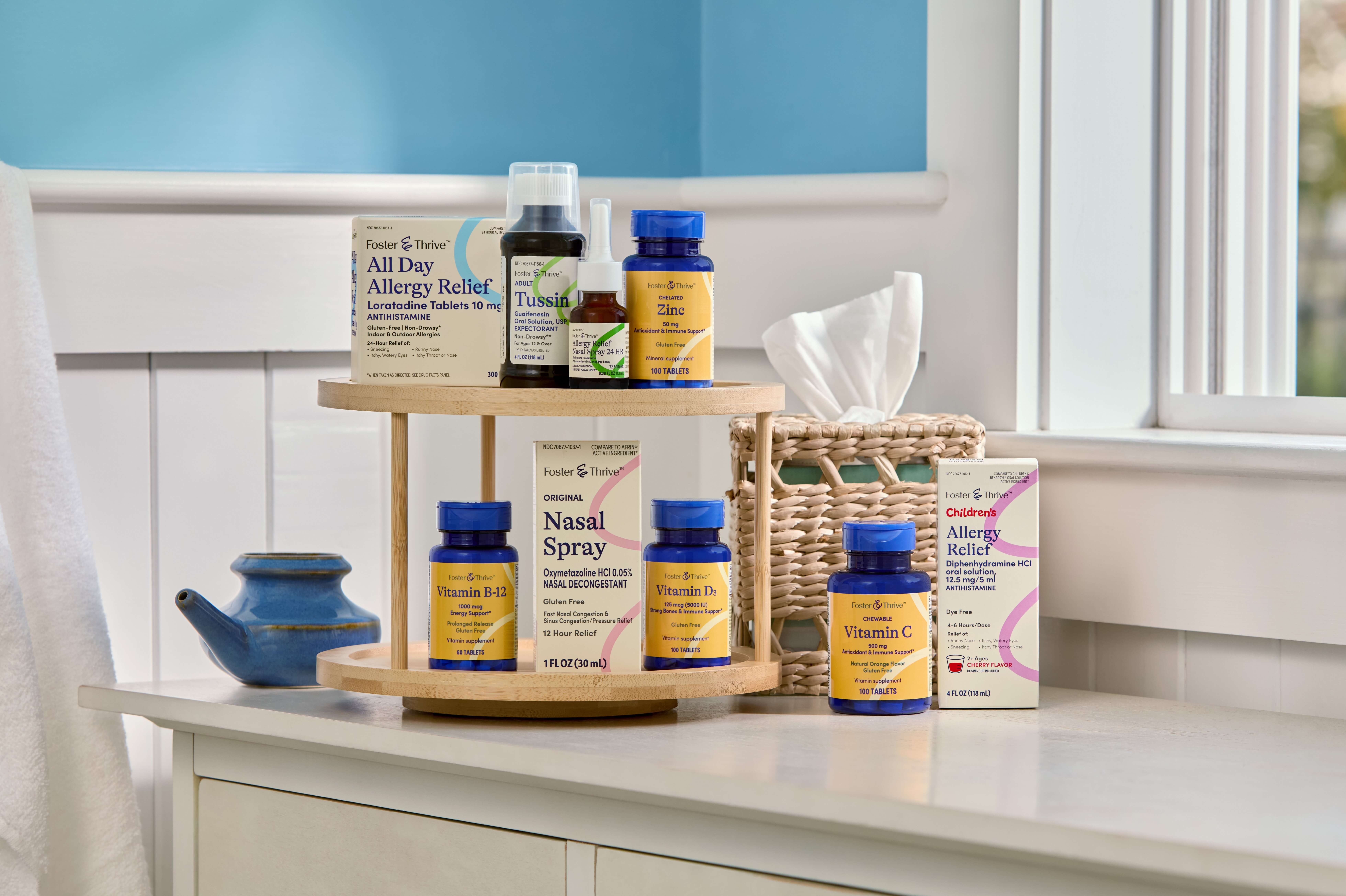 Various health products, including vitamins and allergy relief medications, are displayed on a wooden shelf in a bright bathroom setting.