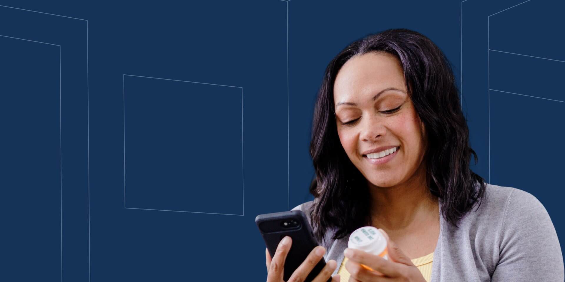 Person holding a smartphone and a prescription bottle, looking at the phone screen.