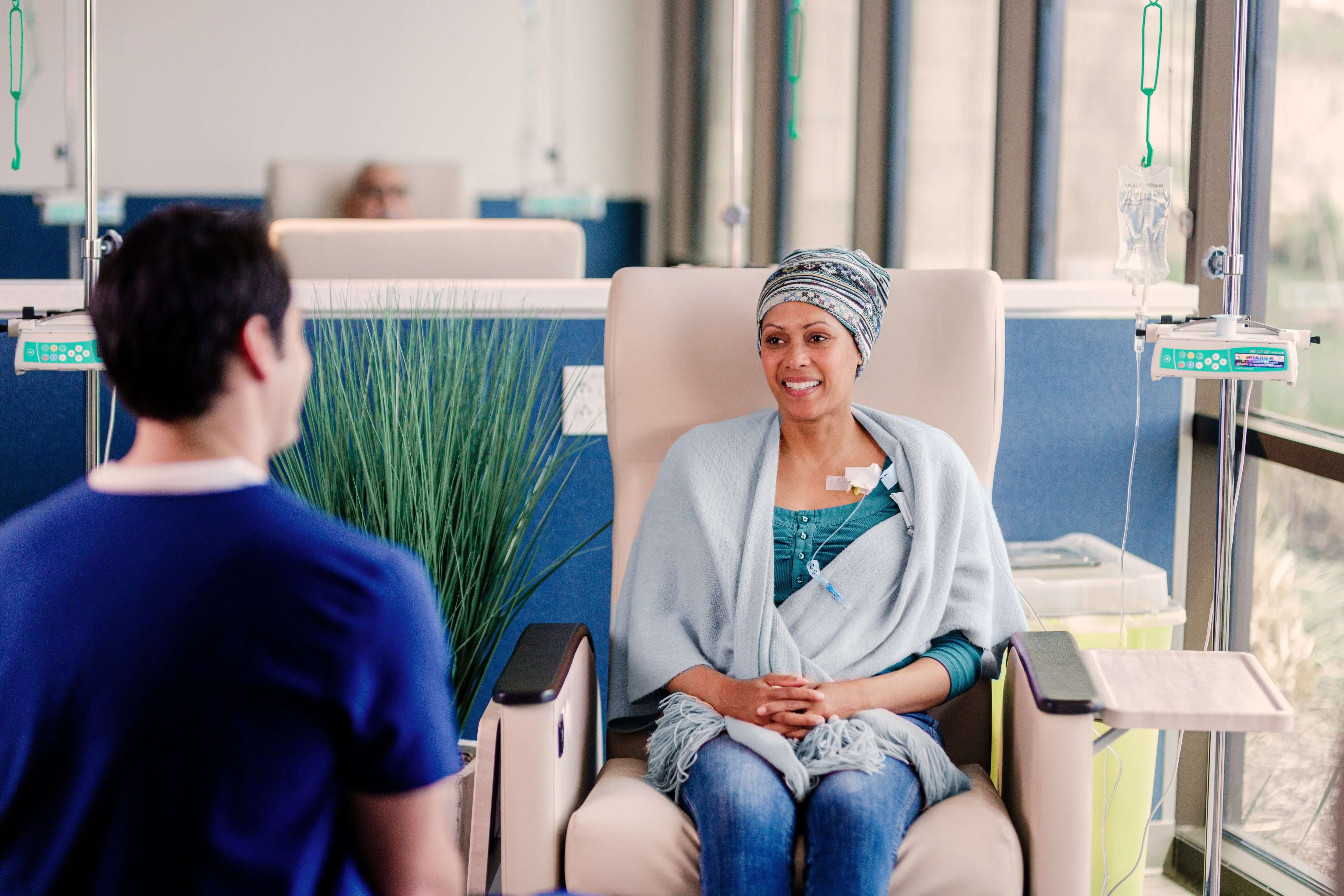 A patient receiving intravenous treatment in a medical facility, with a healthcare worker nearby.A patient receiving intravenous treatment in a medical facility, with a healthcare worker nearby.A patient receiving intravenous treatment in a medical facility, with a healthcare worker nearby.A patient receiving intravenous treatment in a medical facility, with a healthcare worker nearby.A patient receiving intravenous treatment in a medical facility, with a healthcare worker nearby.