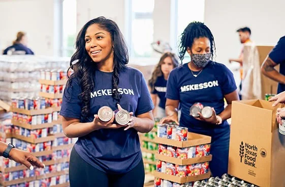 Volunteers in McKesson shirts sorting canned goods at North Texas Food Bank.