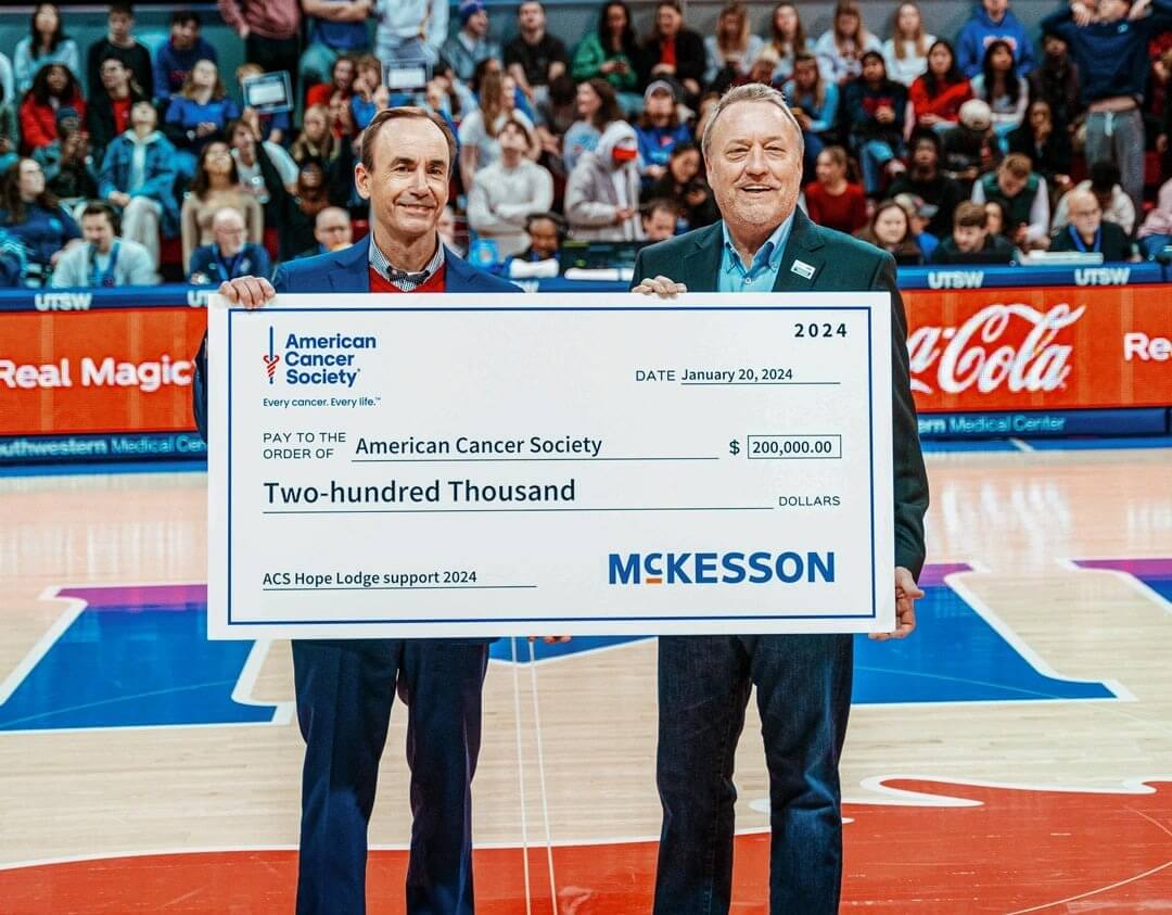CEO Brian Tyler accepting a large check from the American Cancer Society.