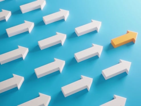 A group of white arrows pointing right with one yellow arrow pointing upward.