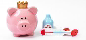 A piggy bank next to toy doctor supplies<br>  