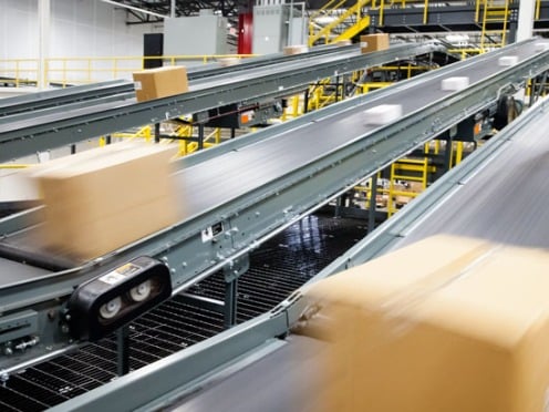 Assembly line conveyor belts moving boxes through a distribution facility