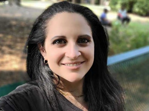 Closeup of Ferial Scott sitting on a bench