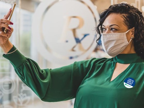 A person wearing a mask taking a selfie