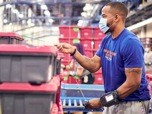 A worker securing shipping containers in a McKesson distribution center