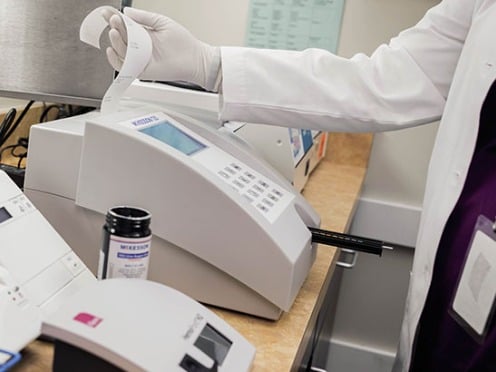 A pharmacist printing out a prescription
