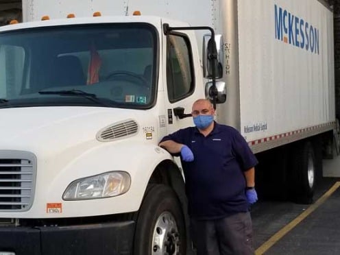 A man standing next to a McKesson truck