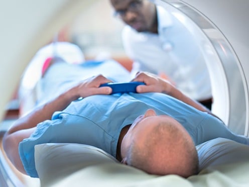 A man lying on a table in an MRI machine