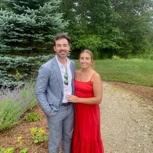 Cody Brown standing with his wife outside on a garden path
